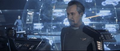 A Man In A Military Uniform Stands In Front Of A Computer Screen GIF