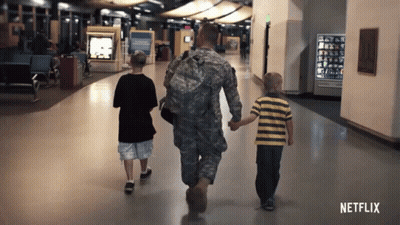 A Man In A Military Uniform Walks With Two Young Boys GIF