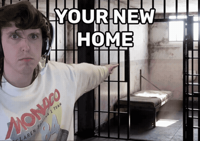 A Man In A Monaco Shirt Is Pointing To A Cell In A Jail Cell GIF