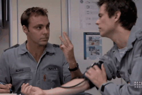 A Man In A Navy Uniform Has His Blood Pressure Checked GIF