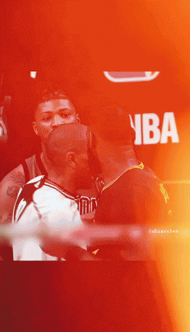 A Man In A Nba Jersey Kisses Another Man In A Dark Room GIF