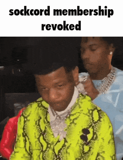 A Man In A Neon Green Snakeskin Jacket Is Being Adjusted By Another Man GIF