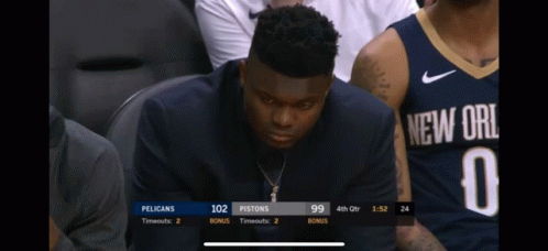 A Man In A New Orleans Jersey Sits In The Stands Watching A Game GIF
