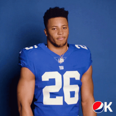 A Man In A New York Giants Jersey Poses For A Photo GIF