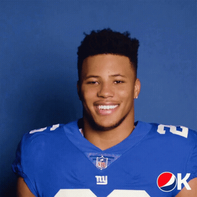 A Man In A New York Giants Uniform Is Holding A Pepsi Can GIF