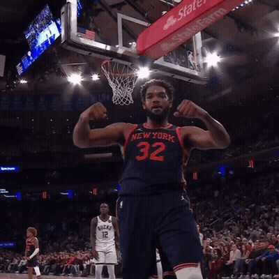 A Man In A New York Jersey Flexes His Muscles GIF