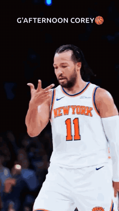 A Man In A New York Knicks Jersey Is Giving A Thumbs Up . GIF