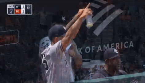 A Man In A New York Yankees Jersey Is Talking To Another Man In A Dugout GIF
