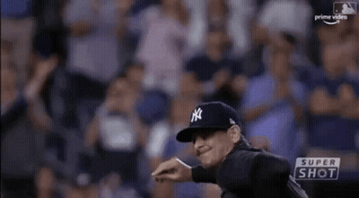 A Man In A New York Yankees Uniform Is Throwing A Baseball . GIF