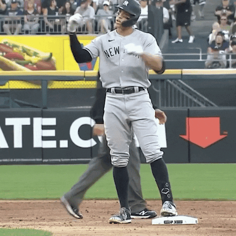A Man In A New York Yankees Uniform Stands On A Base GIF