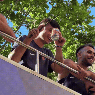 A Man In A Nike Shirt Holds A Can Of Soda GIF