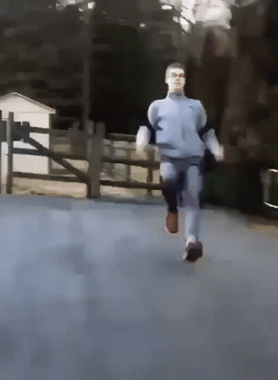 A Man In A Nike Sweatshirt Is Running On A Road GIF