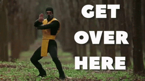 A Man In A Ninja Costume Is Standing In The Woods With The Words " Get Over Here " Behind Him GIF