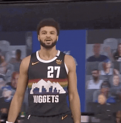A Man In A Nuggets Jersey Stands In Front Of A Crowd GIF