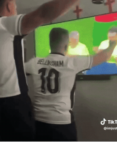 A Man In A Number 10 Jersey Stands In Front Of A Tv GIF
