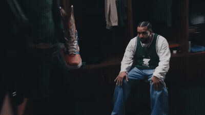 A Man In A Number 3 Jersey Sits In A Locker Room GIF