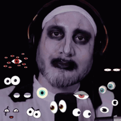 A Man In A Nun Costume Has A Bunch Of Googly Eyes Around His Face GIF