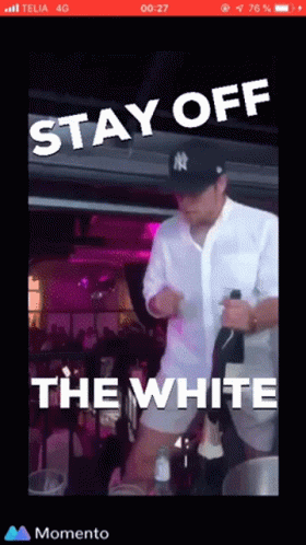 A Man In A Ny Yankees Hat Is Holding A Bottle Of Champagne GIF