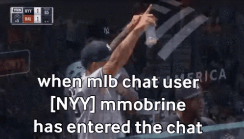 A Man In A Ny Yankees Hat Is Holding A Bottle Of Water In His Hand . GIF