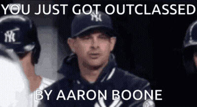A Man In A Ny Yankees Hat Is Talking To His Teammates GIF