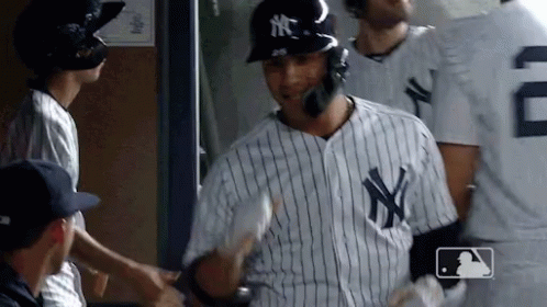 A Man In A Ny Yankees Jersey Shakes Hands With Another Player GIF