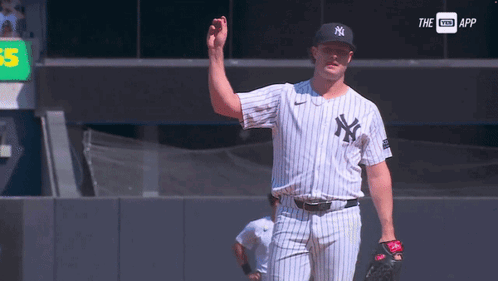 A Man In A Ny Yankees Uniform Is Waving GIF
