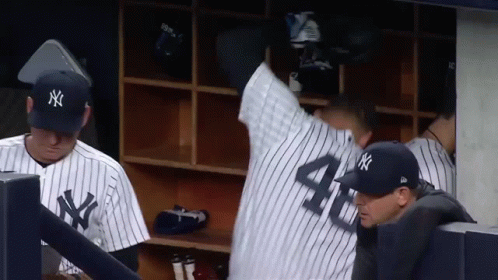 A Man In A Ny Yankees Uniform Stands In The Dugout GIF