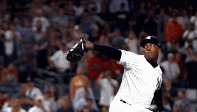 A Man In A Ny Yankees Uniform Throws A Ball GIF