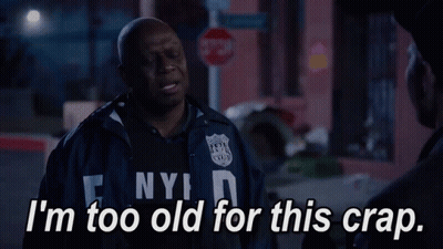A Man In A Nypd Jacket Talks To Another Man GIF