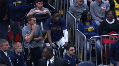 A Man In A Pacers Shirt Sits In The Stands Watching A Game GIF