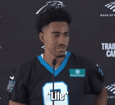 A Man In A Panthers Jersey Is Talking Into A Microphone And Says " What A Beautiful Thing " GIF