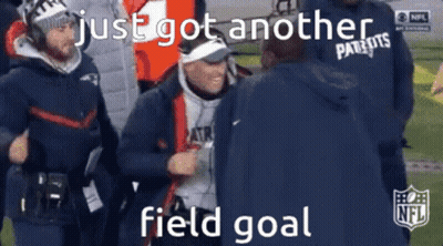 A Man In A Patriots Jacket Is Talking To Another Man On A Football Field GIF