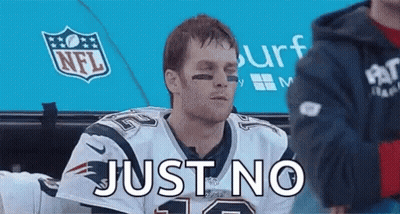 A Man In A Patriots Jersey Is Sitting In A Dugout With The Words Just No Written On His Face . GIF