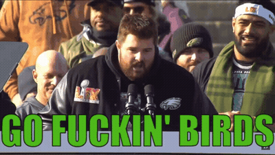 A Man In A Philadelphia Eagles Shirt Stands In Front Of A Microphone With The Words Go Fuckin Birds Above Him GIF
