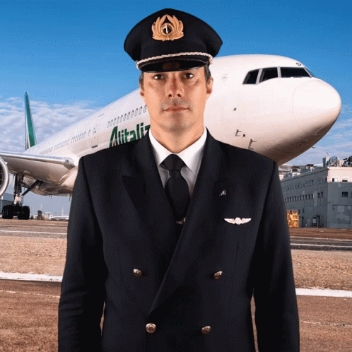 A Man In A Pilot 'S Uniform Stands In Front Of An Alitalia Airplane GIF