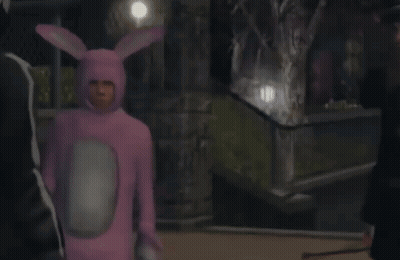 A Man In A Pink Bunny Costume Is Standing Next To A Man In A Black Suit GIF