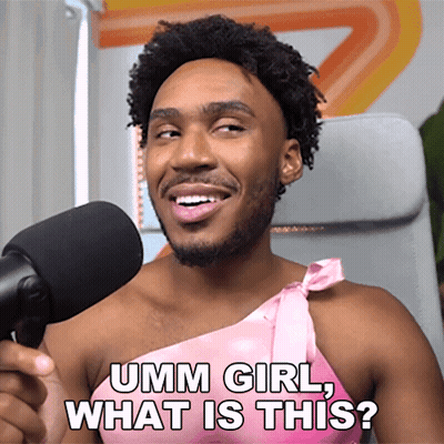 A Man In A Pink Dress Is Talking Into A Microphone And Asking " Umm Girl What Is This " GIF