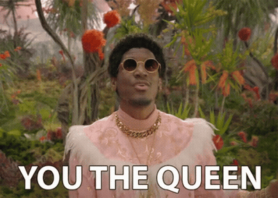 A Man In A Pink Feathered Outfit Says " You The Queen " GIF