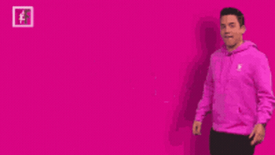 A Man In A Pink Hoodie Is Pointing To The Word Pink GIF