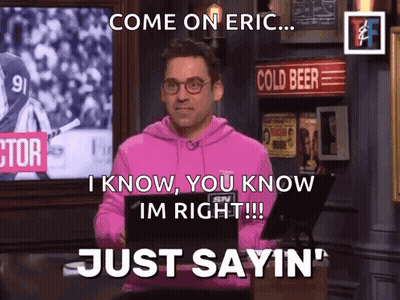A Man In A Pink Hoodie Is Standing In Front Of A Sign That Says Cold Beer GIF