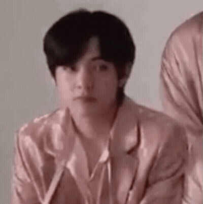 A Man In A Pink Jacket Is Sitting Next To Another Man In A Pink Jacket . GIF
