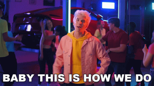 A Man In A Pink Jacket Stands In Front Of A Crowd With The Words Baby This Is How We Do GIF
