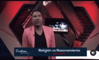 A Man In A Pink Jacket Stands In Front Of A Screen That Says Religion Vs Razonamiento GIF