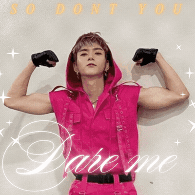 A Man In A Pink Outfit Is Flexing His Muscles And The Words Dare Me Are Behind Him GIF