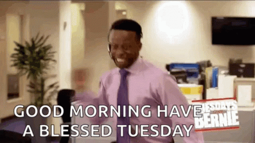 A Man In A Pink Shirt And Tie Is Wearing A Headset And Saying `` Good Morning Have A Blessed Tuesday '' . GIF