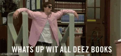 A Man In A Pink Shirt Is Dancing In A Library With The Words Whats Up Wit All Deez Books Behind Him . GIF