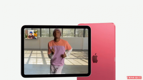 A Man In A Pink Shirt Is Dancing On A Tablet Screen GIF