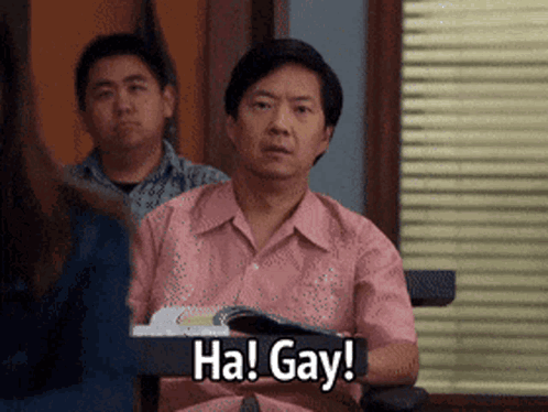 A Man In A Pink Shirt Is Holding A Book And Saying Ha Gay GIF