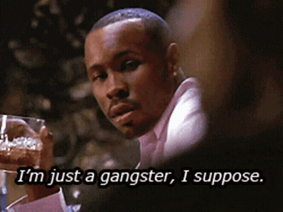 A Man In A Pink Shirt Is Holding A Glass Of Beer And Says I 'M Just A Gangster I Suppose GIF