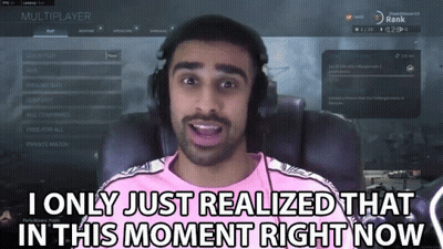 A Man In A Pink Shirt Is Playing A Video Game And Says " I Only Just Realized That In This Moment Right Now " GIF